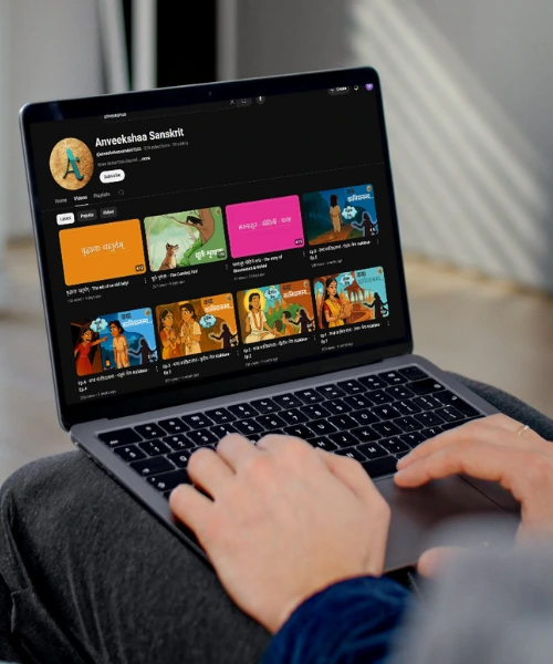 “Person learning Sanskrit on Anveekshaa YouTube channel using a laptop.